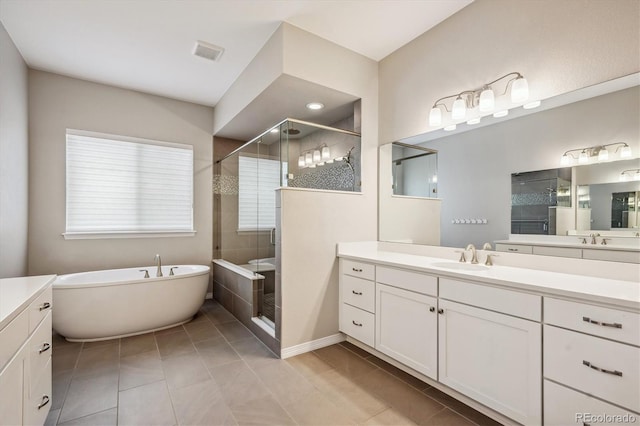 bathroom with vanity, tile patterned floors, and independent shower and bath