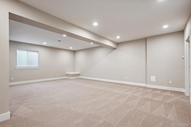 basement featuring light carpet