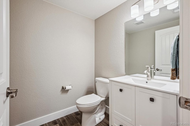 bathroom with vanity, hardwood / wood-style flooring, and toilet