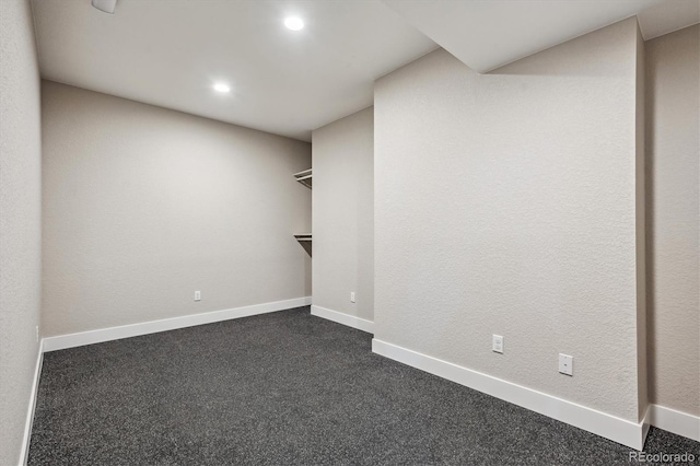 empty room featuring dark colored carpet