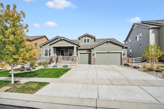 craftsman house featuring a front yard, a garage, and a porch