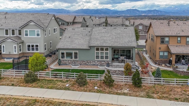 rear view of house with a patio and a mountain view