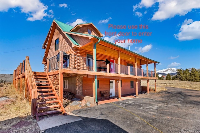1528 Silverheels Rd, Fairplay, CO 80440 - view of front facade with stone siding, stairs, and a wooden deck