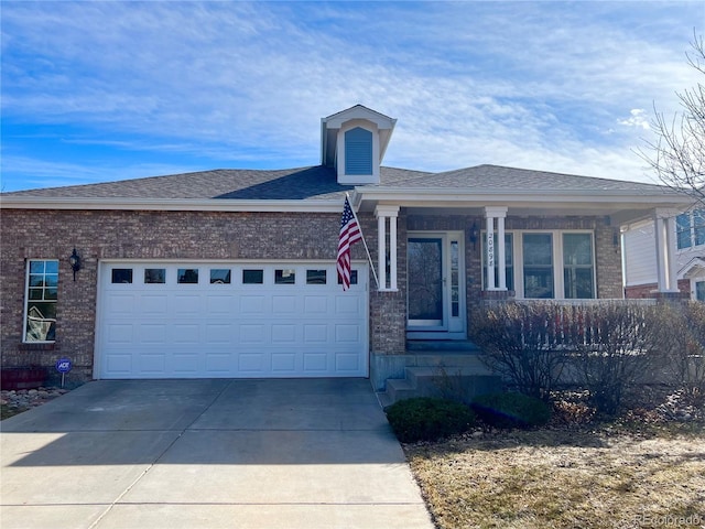 view of front facade with concrete driveway, brick siding, a garage, and roof with shingles