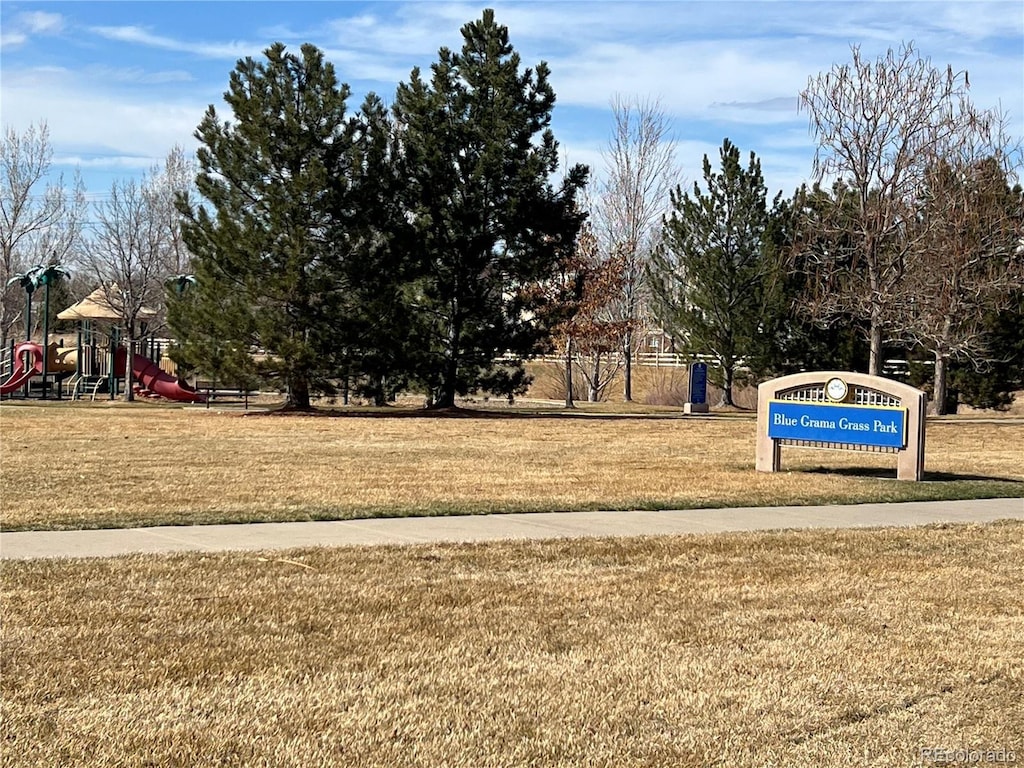 view of property's community with a yard and playground community