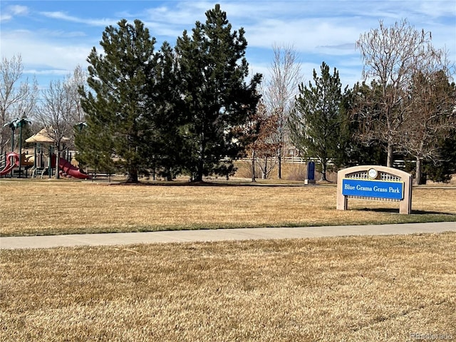 view of property's community with a yard and playground community