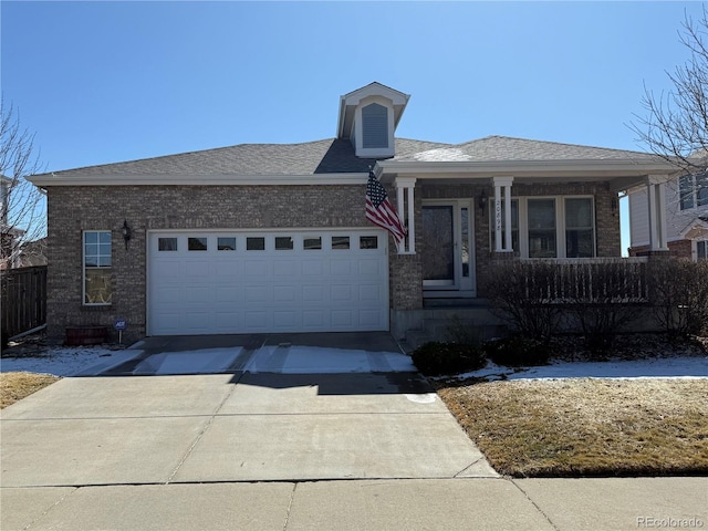 view of front facade featuring a porch, concrete driveway, a shingled roof, a garage, and brick siding