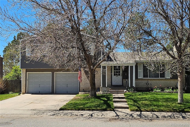 view of front of property with fence, driveway, a front lawn, and brick siding