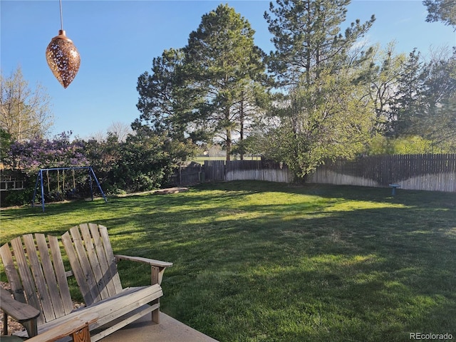 view of yard with a playground and a fenced backyard