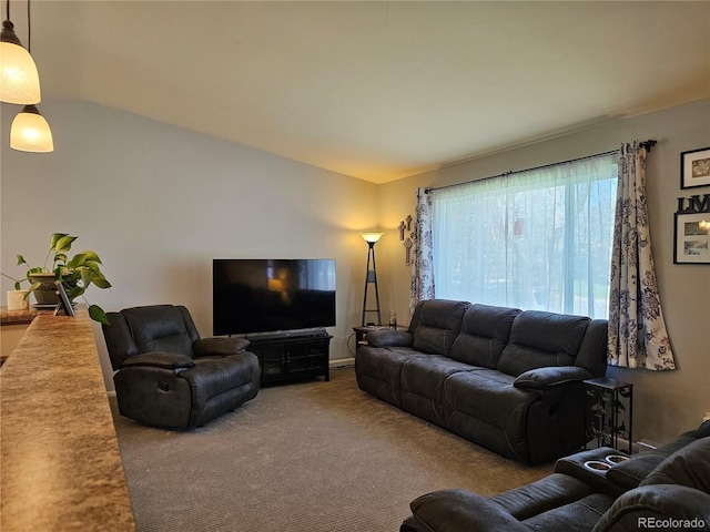living room featuring carpet and vaulted ceiling