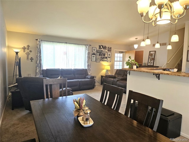 dining area with stairs, a notable chandelier, light carpet, and visible vents