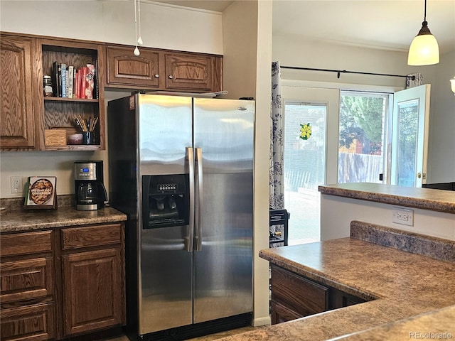 kitchen featuring stainless steel fridge, open shelves, dark countertops, pendant lighting, and dark brown cabinetry