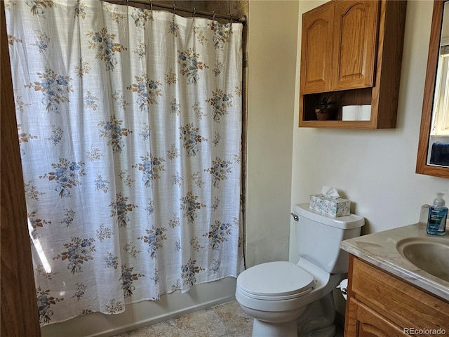full bath with toilet, vanity, and shower / bath combo with shower curtain