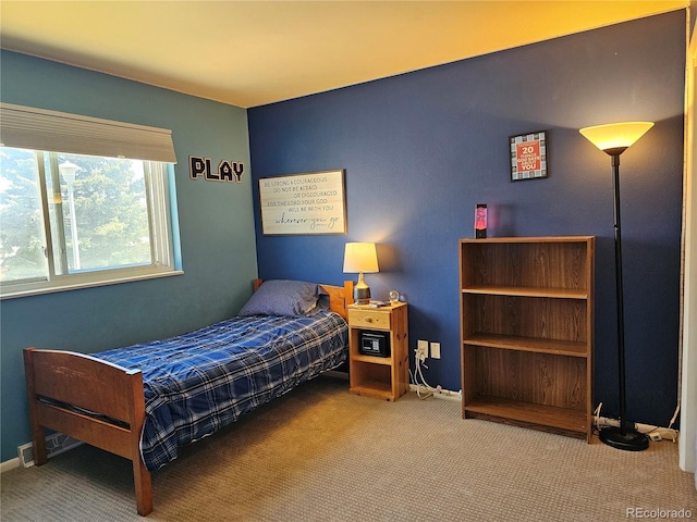 carpeted bedroom featuring baseboards and visible vents
