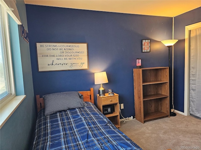carpeted bedroom with baseboards