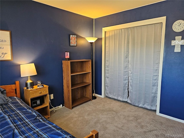carpeted bedroom featuring baseboards
