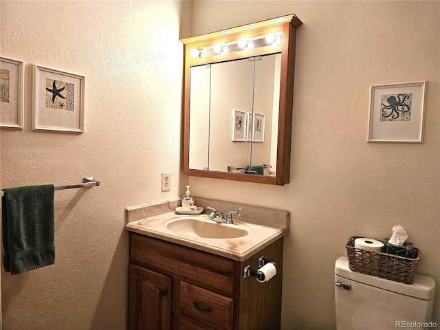 bathroom with toilet and vanity