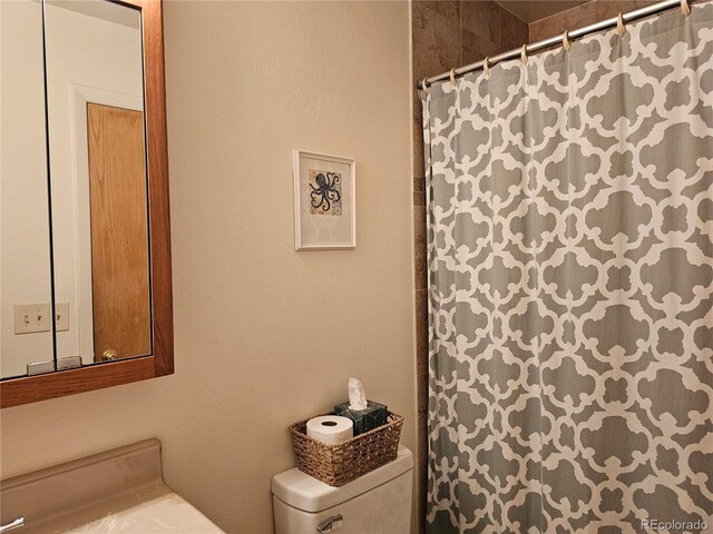 4609 S Kalispell Way, Aurora, CO 80015 - bathroom featuring toilet and a shower with shower curtain