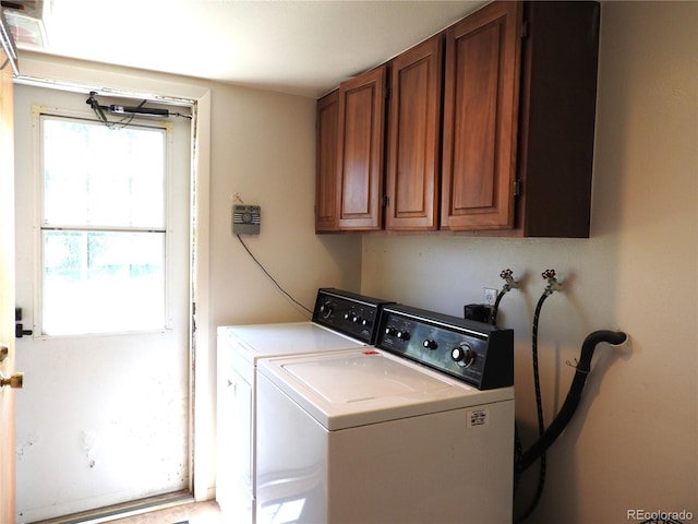 laundry area with cabinet space and separate washer and dryer