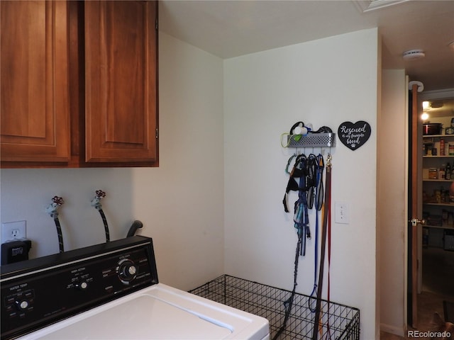 laundry room featuring washer / clothes dryer and cabinet space