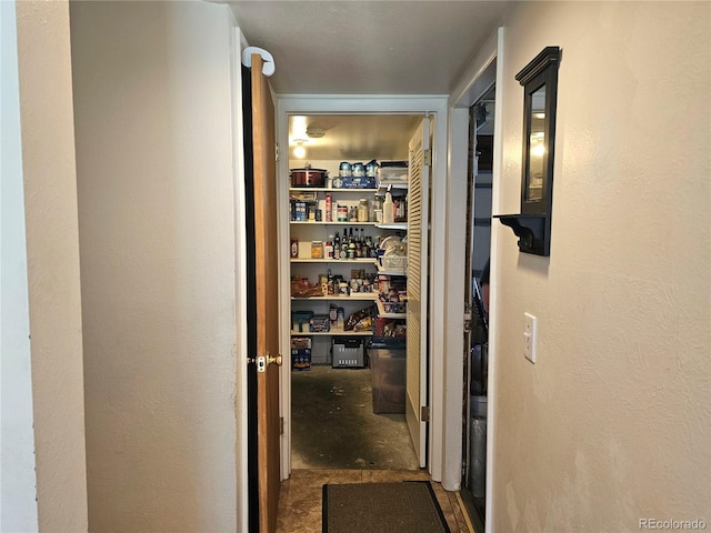 corridor with unfinished concrete flooring