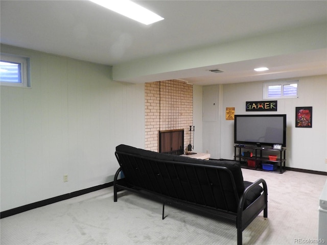 living area with baseboards, a wealth of natural light, a brick fireplace, and carpet