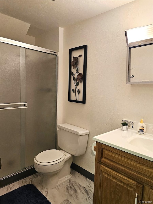 full bath with toilet, marble finish floor, vanity, a shower stall, and baseboards