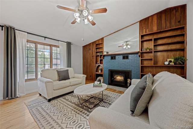 7563 Lamar Ct, Arvada, CO 80003 - living room featuring ceiling fan, light wood-style floors, lofted ceiling, built in features, and a brick fireplace