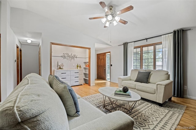 7563 Lamar Ct, Arvada, CO 80003 - living area featuring lofted ceiling, light wood-style flooring, and a ceiling fan