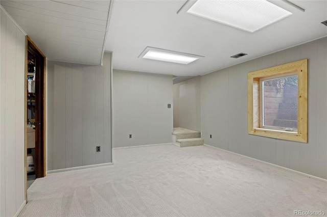 7563 Lamar Ct, Arvada, CO 80003 - basement with carpet flooring, stairs, and wood walls