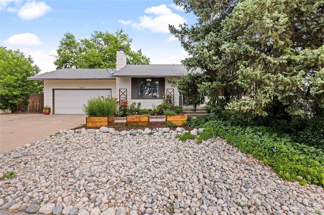 7563 Lamar Ct, Arvada, CO 80003 - view of front of property featuring a garage, concrete driveway, and a chimney