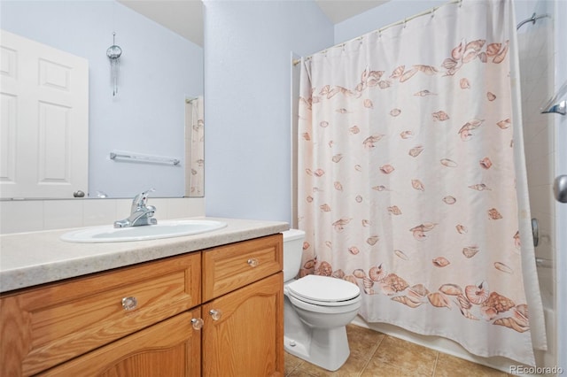 bathroom featuring tile patterned floors, vanity, and toilet