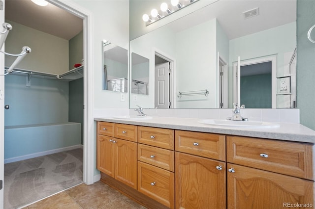 bathroom with tile patterned floors and vanity