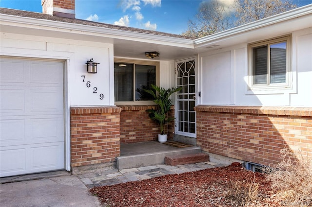 doorway to property with brick siding and a chimney