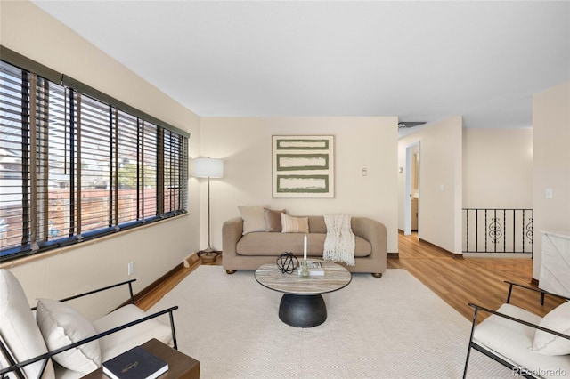 living area with visible vents and wood finished floors