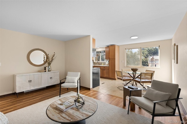 sitting room featuring light wood-style flooring and baseboards