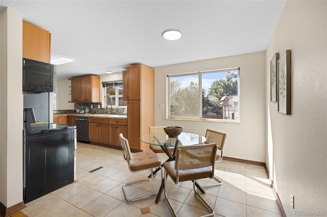 dining area featuring light tile patterned floors and baseboards