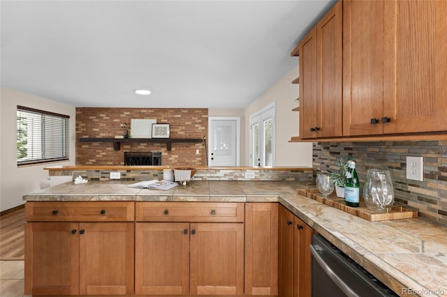 kitchen featuring backsplash, baseboards, dishwasher, a peninsula, and open shelves