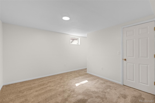 below grade area featuring baseboards and carpet floors