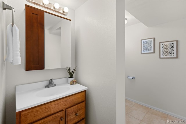 bathroom with tile patterned floors, baseboards, and vanity