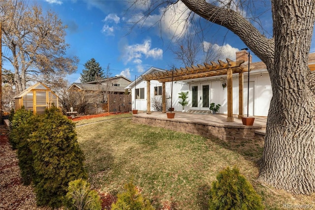 rear view of house with a patio, fence, an exterior structure, french doors, and an outdoor structure