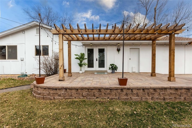 back of property with french doors, a patio area, and a pergola