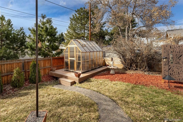 view of yard with an outbuilding, an exterior structure, and a fenced backyard