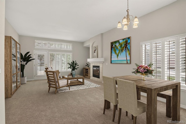7400 W Grant Ranch Blvd Unit 9, Littleton, CO 80123 - dining room featuring light colored carpet, healthy amount of natural light, a chandelier, and a tile fireplace