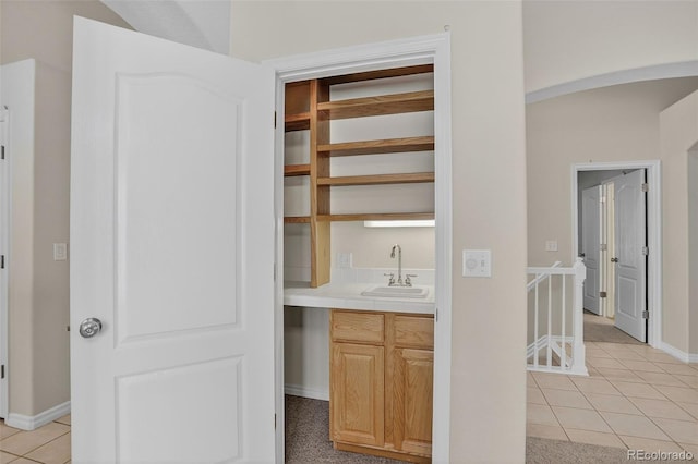 7400 W Grant Ranch Blvd Unit 9, Littleton, CO 80123 - indoor wet bar featuring light tile patterned floors and arched walkways