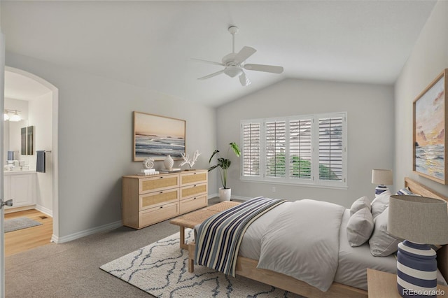7400 W Grant Ranch Blvd Unit 9, Littleton, CO 80123 - bedroom with arched walkways, lofted ceiling, light colored carpet, ensuite bath, and a ceiling fan
