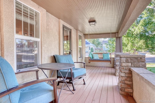 wooden terrace featuring covered porch