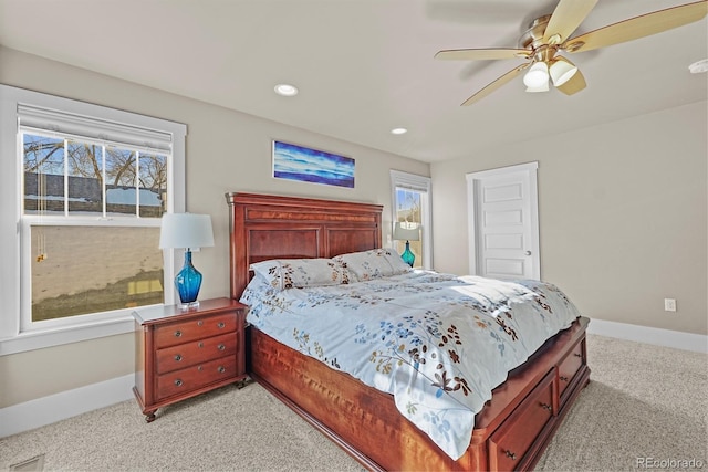 carpeted bedroom with ceiling fan and multiple windows