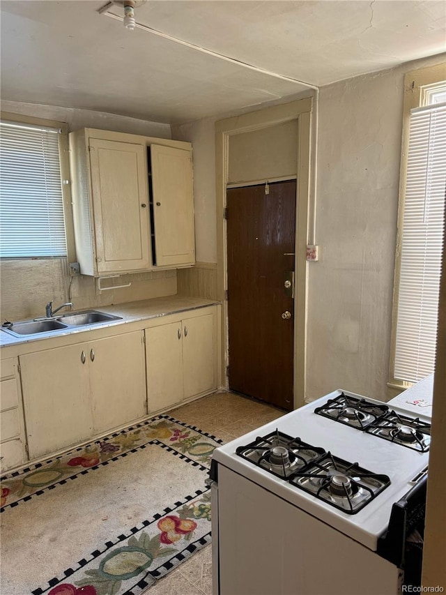 kitchen with sink and gas range gas stove