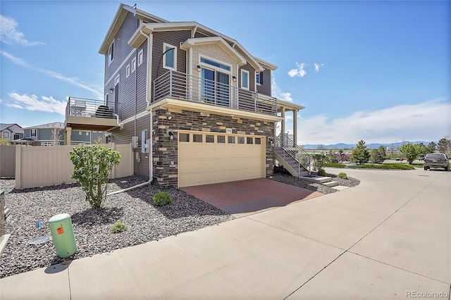 view of front facade with a garage and a balcony